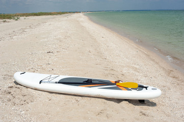 SUP board, stand up paddle near the sea on the beach