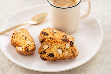 Italian biscotti cookies with a cup of coffee on a light background.