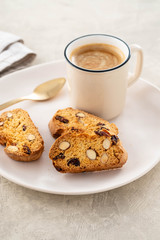 Italian biscotti cookies with a cup of coffee on a light background.