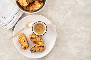 Italian biscotti cookies with a cup of coffee on a light background.