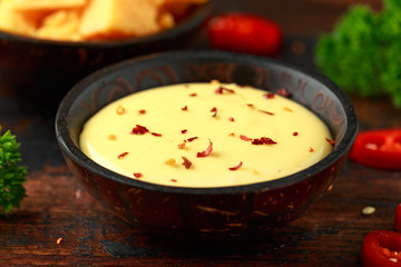 Homemade Cheese Sauce with spice on wooden table