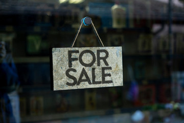simple sign board frame hanging on the wall of the resident building exterior with word for sale