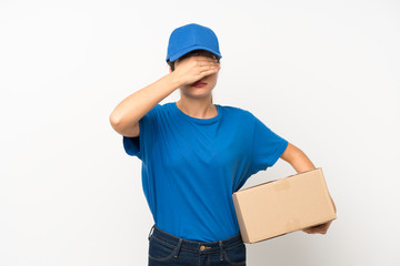 Young delivery girl over isolated white background covering eyes by hands