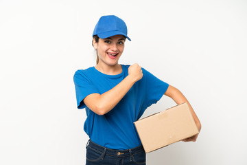 Young delivery girl over isolated white background celebrating a victory