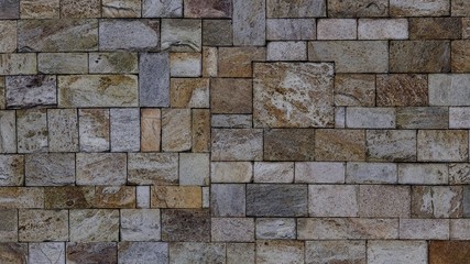 Background texture image of wall covered with rough tiles.