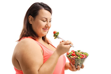 Woman eating a salad and trying to lose weight