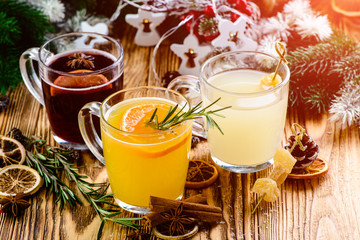 Selection of various autumn traditional drinks, set punch and mulled wine on christmas rustic...