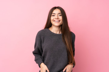 Young woman over isolated pink background laughing