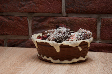 sprinkles and topping. homemade chocolate. Homemade choco candies in milk chocolate basket. chocolate art figure. sweet food and calorie. Truffles with Nuts and Marzipan. candy shop