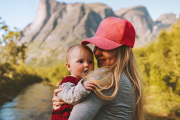 Mother and infant baby walking outdoors family travel healthy lifestyle young woman holding child summer vacations in mountains Mothers day holiday