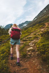 Fototapeta premium Woman traveling in mountains hiking with backpack adventure healthy lifestyle outdoor summer activity trekking in Norway