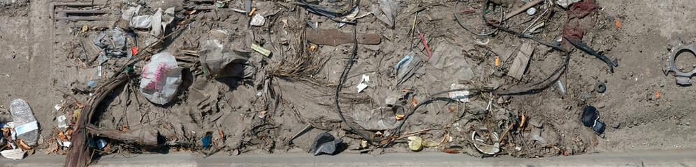 Dirt and trash that collected in a gutter.