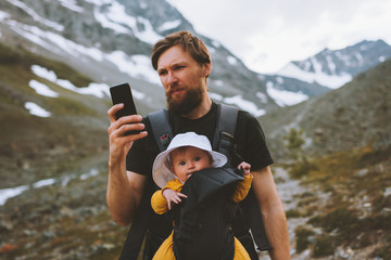 Travel family father and daughter baby carrier hiking in mountains adventure vacations with child...