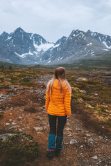 Naklejka premium Traveler woman enjoying mountains view outdoor adventure hiking activity vacations alone healthy lifestyle woman exploring Lyngen Alps in Norway