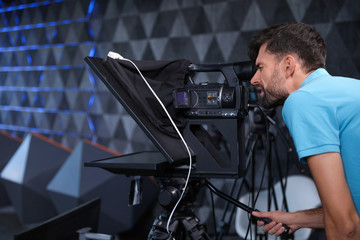 Professional video camera operator working in studio