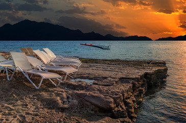 Resting point on a shore of coral reef, stone beach of the Red Sea as dawn