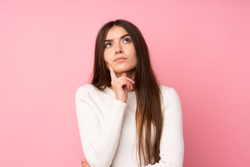 Young woman over isolated pink background thinking an idea