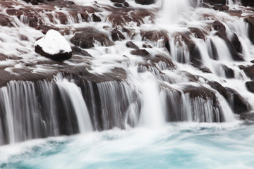 Hraunfossar is a series of waterfalls formed by rivulets streaming over a distance of about 900...