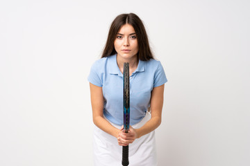 Young girl over isolated white wall playing tennis