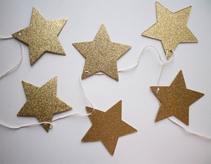 garland of golden stars. flat lay style. xmas holiday theme