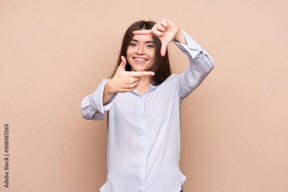 Wall mural Young woman over isolated background focusing face. Framing symbol - Wall murals