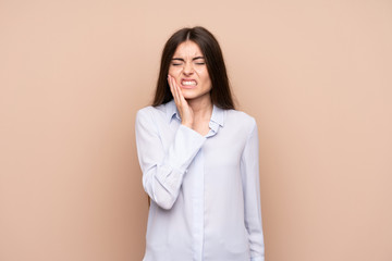 Young woman over isolated background with toothache