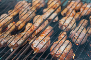 Closeup of chicken legs on the barbecue in outdoor