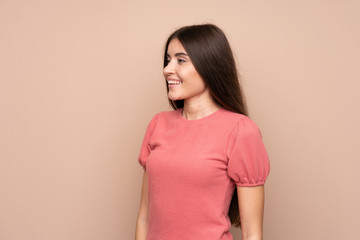Fototapeta premium Young woman over isolated background looking to the side