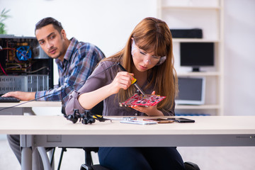 Fototapeta premium Two technicians working at computer warranty center