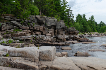 Fototapeta na wymiar Rapid moving water at Pabineau Falls, New Brunswick, Canada