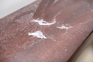 A lot of dust on wooden polished surface of furniture, dusty home concept