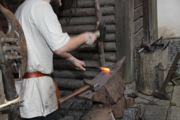 A Blacksmith Models A Bar Of Iron With Hammer After Took It From Fire Forge 
