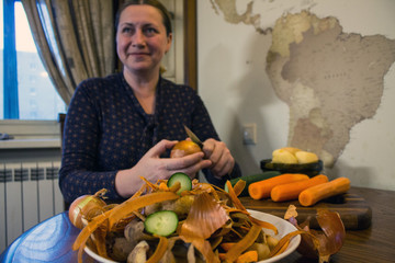 Peeling vegetables and a woman peeling onions from the skin