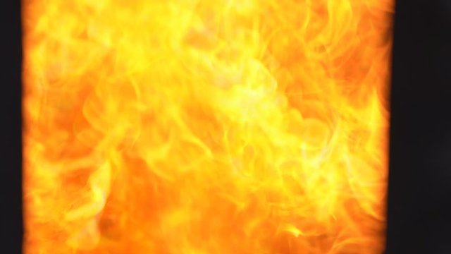 Slow motion fire flame cremate death people on dark background, red and orange flame glowing