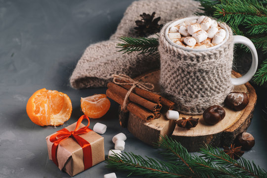 Hot Winter Drink Chocolate, Cocoa Or Coffee With Marshmallows On The Table In A Knitted Mug With Cinnamon