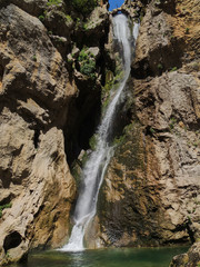 Fototapeta na wymiar The waterfall of Salto de los Órganos on the route of the Borosa River in the Natural Park of the Sierra de Cazorla, Segura and Las Villas. In Jaén, Andalusia. Spain