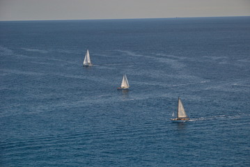 Obraz premium Barcelona, Spain - 18.08.2019: Beautiful white sailing yacht in the blue huge sea