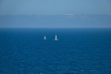 Barcelona, Spain - 18.08.2019: Beautiful white sailing yacht in the blue huge sea