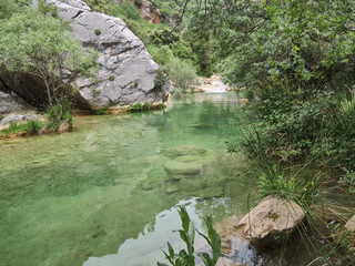 Naklejka na ściany i meble Cascades of the Guadalquivir River as it passes through Cerrada de Utrero in the Natural Park of the Sierra de Cazorla, Segura and Las Villas. In Jaén, Andalusia. Spain