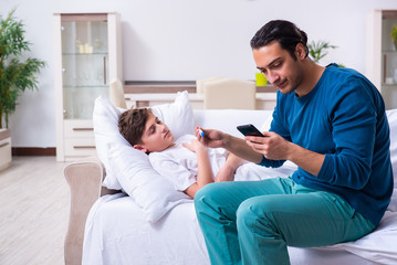 Young father caring for sick son