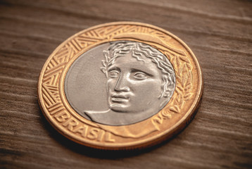  Coin, Real, Reais, Brazilian Currency. One Real coin on a object wooden.