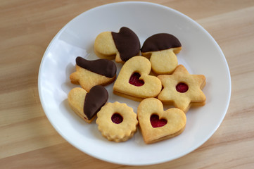 Christmas linzer sweets and cookies made from shortcrust pastry, various shapes filled with marmalade, decorated with chocolate