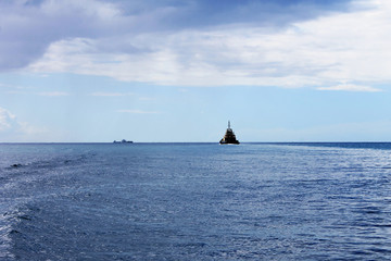 A tugboat moving across the water toward a tanker ship, Caribbean Sea, St. Lucia, West Indies