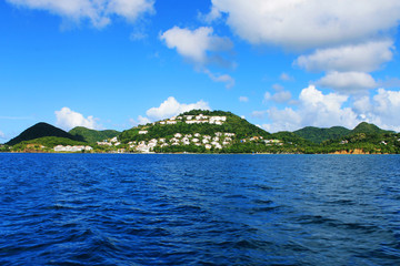 Looking from a boat at the houses and buildings on the shore and hills, St. Lucia, West Indies