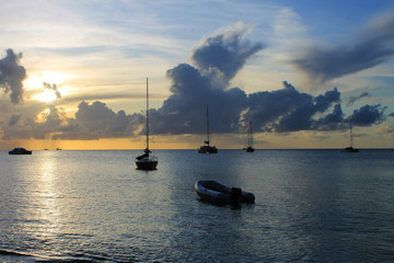 Sailboats and a Zodiac on the Caribbean Sea at sunset, St. Lucia, West indies.