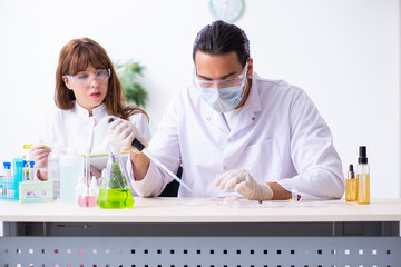 Two chemists working in the lab