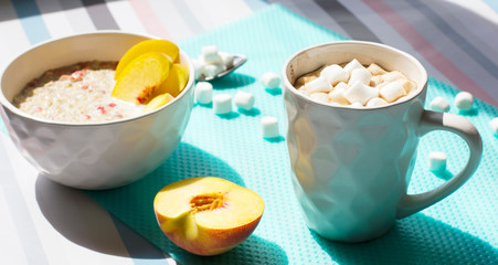 Cereals with milk and fruits. Hot chocolate with marshmallows