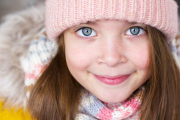 Cute little girl in a warm hat