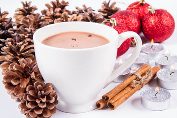 Cup of hot chocolate ,Cup of hot chocolate with marshmallows, and some cinnamon sticks, cones, christmas balls and candles	  some cinnamon sticks, cones, christmas balls and candles