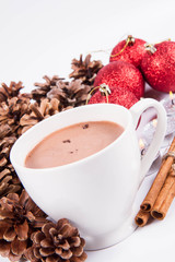 Cup of hot chocolate ,  some cinnamon sticks, cones, christmas balls and candles